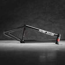 The Kink Contender 2 Frame, a durable black BMX bike frame and Dan Coller signature model, stands against a dark background with white text along its top tube.