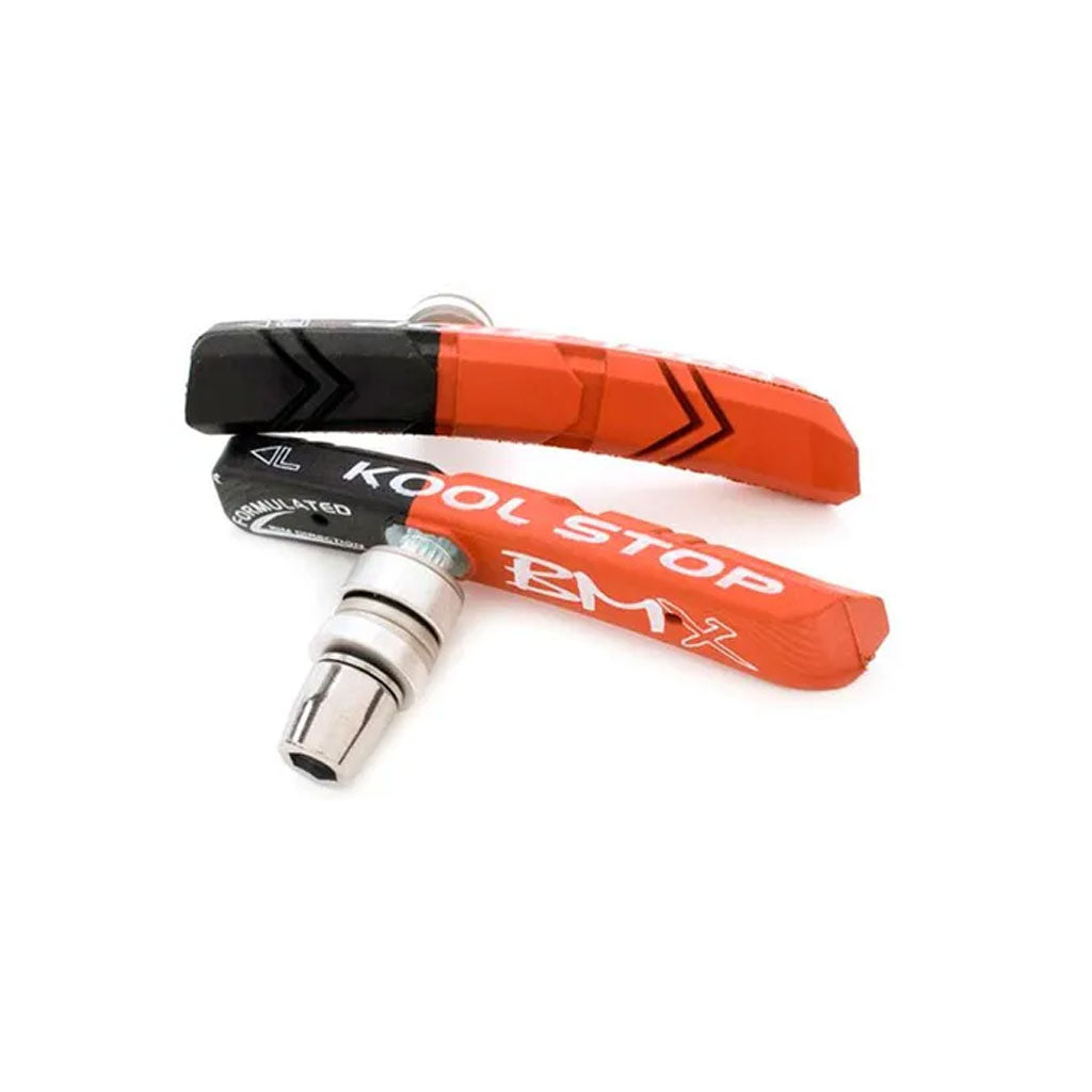 A pair of Kool Stop BMX Brake Pads in black and red, featuring a metal attachment and a curved design.