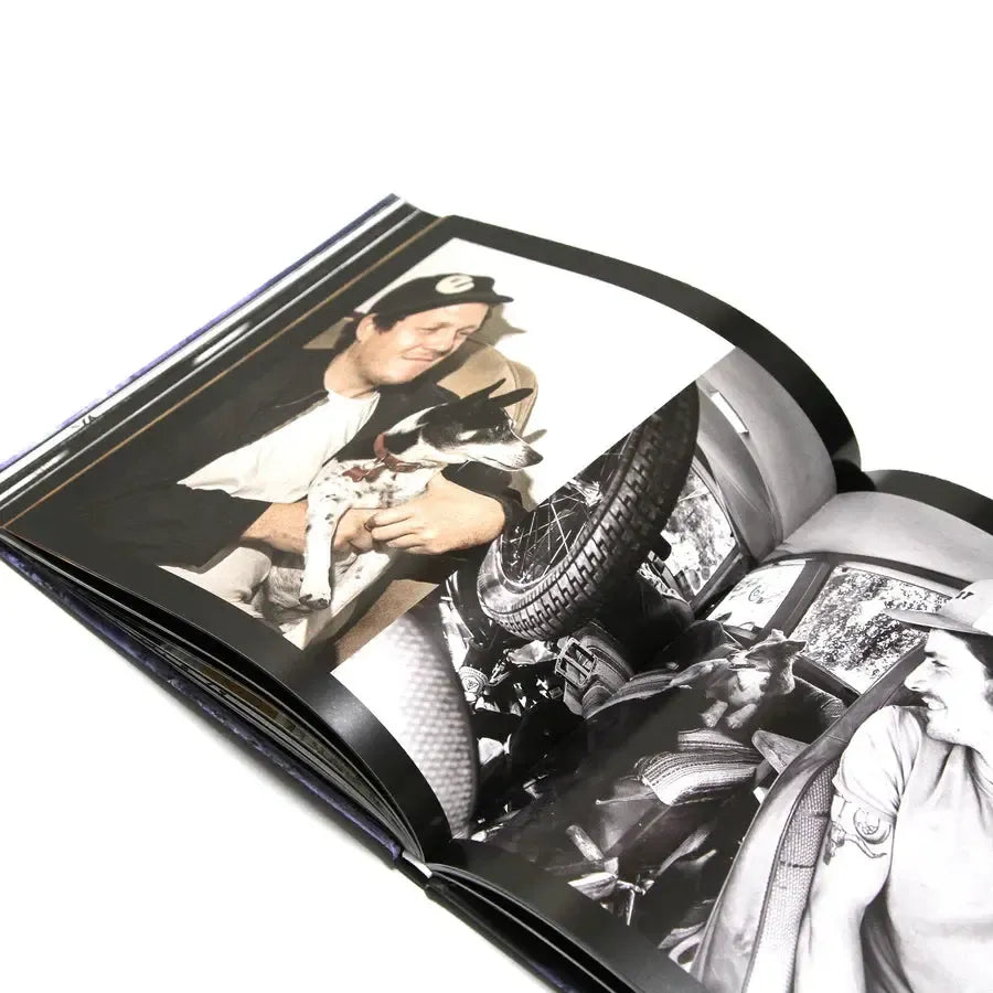 The MAINTAIN - IV.V "DERAILED" Book includes a photo of a man holding a small dog and another by Rob Dolecki showing a man in a vehicle surrounded by assorted items.