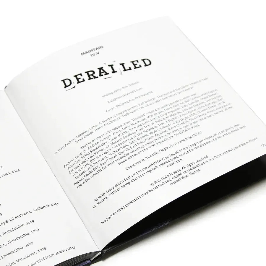 Open booklet displaying the title page with "DERAILED" in bold, featuring Rob Dolecki’s train photography in the unique MAINTAIN - IV.V "DERAILED" BMX photo book, printed in black on white paper.