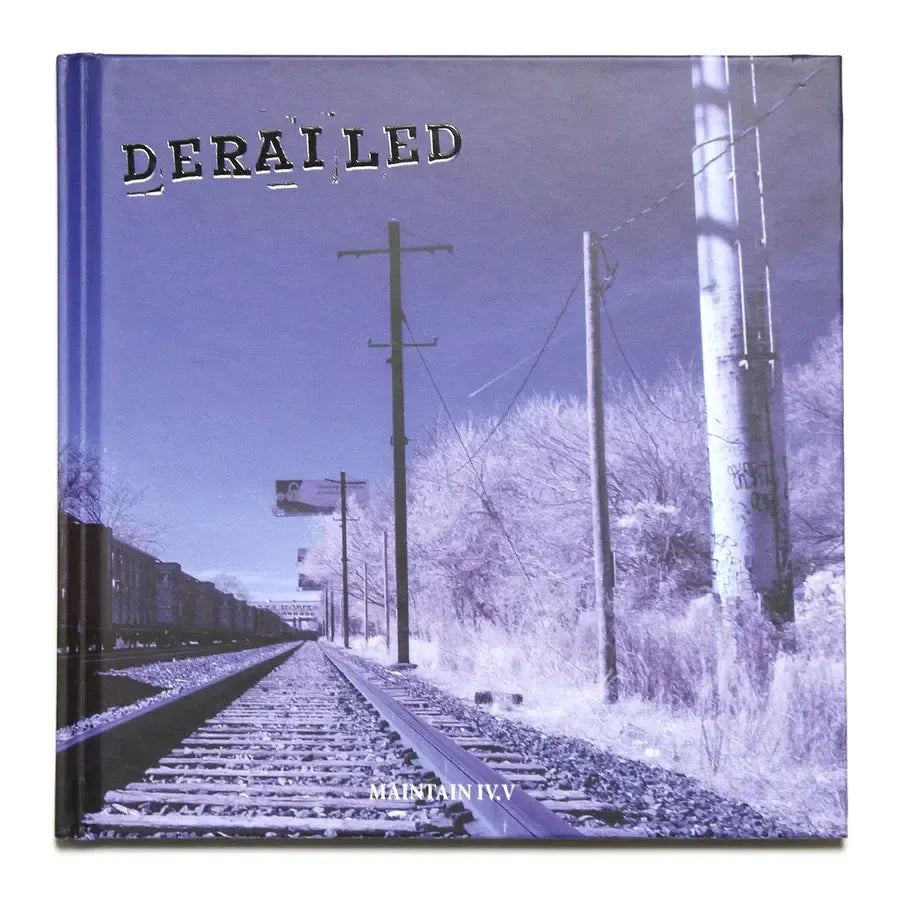 The "MAINTAIN - IV.V 'DERAILED'" book features a striking cover image of railroad tracks and utility poles under a clear sky, ideal for train photography enthusiasts and fans of evocative visuals similar to Rob Dolecki’s work.