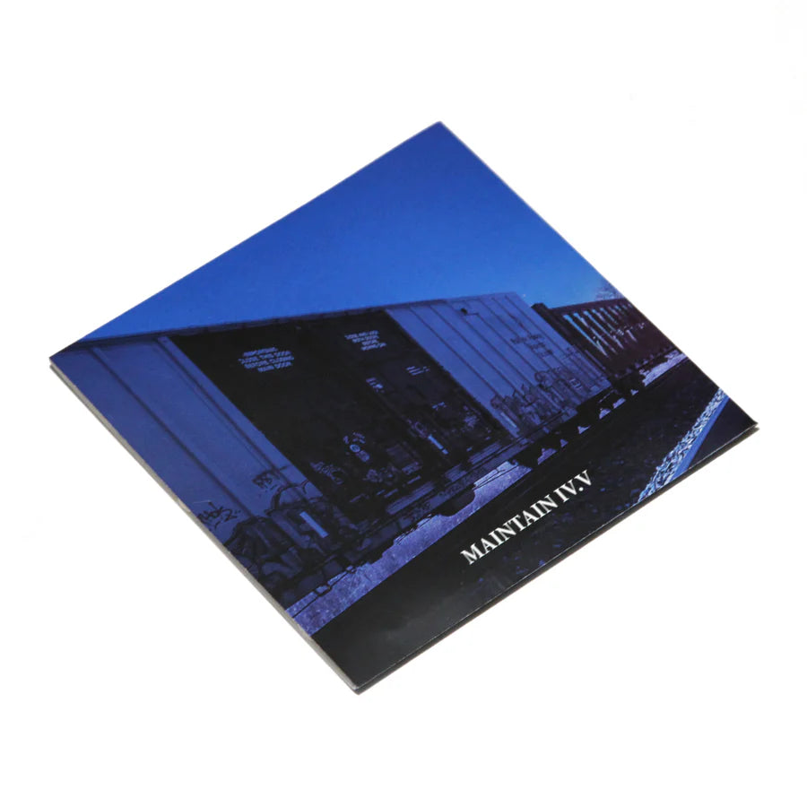 A square booklet titled "MAINTAIN - IV.V 'DERAILED' Book" featuring a cover photo of train cars under a blue sky—an impressive piece of train photography by Rob Dolecki.