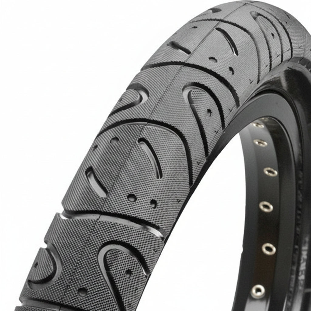 Close-up of the Maxxis Hookworm 20 Inch Tyre, highlighting its durable, textured tread and a row of silver eyelets along the wheel rim.