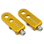 Two gold-colored MCS 3/8 Inch (10mm) Chain Tensioners made from durable 6061-T6 aluminum, each featuring circular holes and bolts, are displayed side by side on a white background.