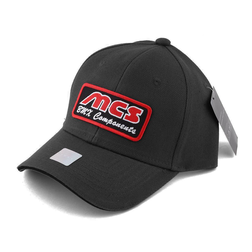 The MCS Logo Cap is a black baseball hat featuring a red and white "MCS BMX Components" patch on the front, snap fit design for easy adjustment, a side tag, and fits most sizes.