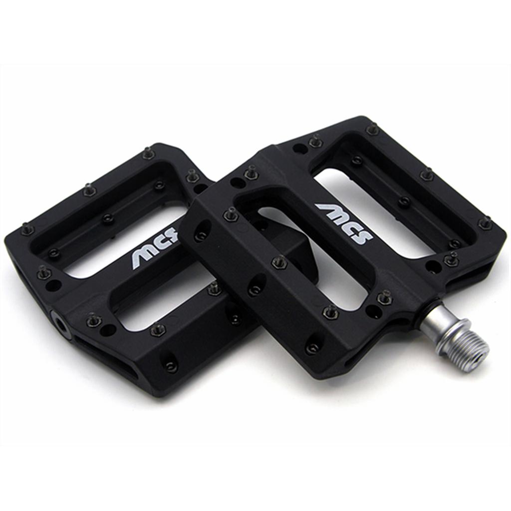 The MCS Sealed Pedals are black platform pedals with metal pins, exposed screw threads, and white "MCS" logos—ideal for BMX riders seeking durable, high-performance sealed pedals.