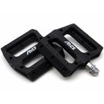 The MCS Sealed Pedals are black platform pedals with metal pins, exposed screw threads, and white "MCS" logos—ideal for BMX riders seeking durable, high-performance sealed pedals.