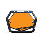 The Mac Components Junior Plate Inserts feature a hexagonal black and orange design with "MAC" on top, "ONE" on the right, four mounting holes, and a bold "WeFast" graphic—ideal for riders racing under UCI rules.