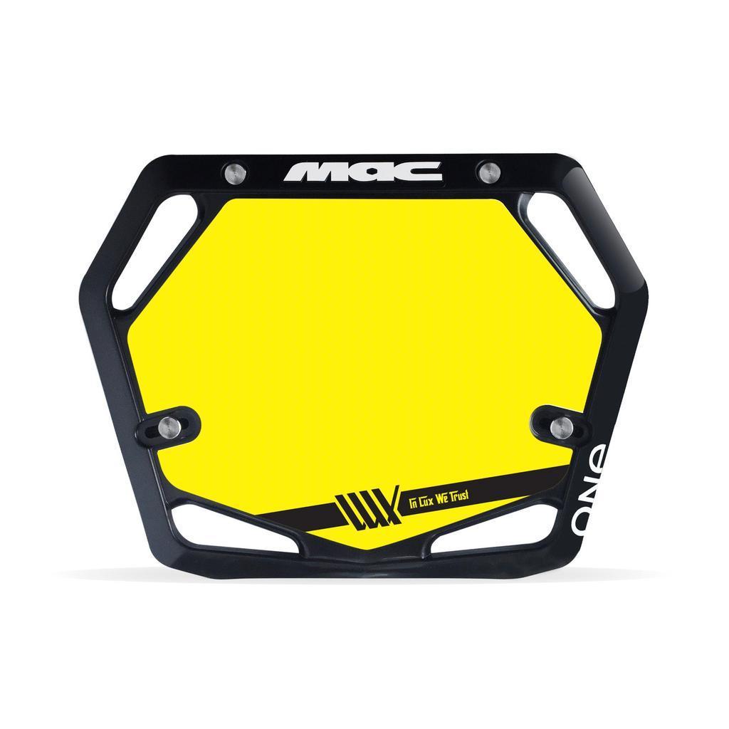 The Mac Components Pro Plate Inserts are hexagonal yellow background plates with a black border, MAC and ONE logos, and a black stripe. UCI AusCycling compliant, they feature a stylized yellow graphic for use as Mac Pro Plate backing inserts.