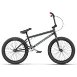 A black Wethepeople CRS 20 Inch Bike with Salt Rookie Chromoly Three Piece Cranks and Eclat Surge Pedals on a white background.