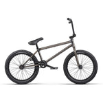 A black Wethepeople Justice 20 Inch Bike featuring a sleek frame, thick tires, a padded seat, and adjustable handlebars, positioned on a neutral background.