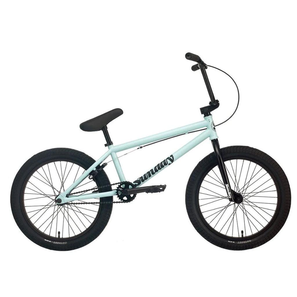 The Sunday Primer 20 Inch Bike is a light blue BMX bicycle with black handlebars, seat, and tires, featuring pro-level geometry.