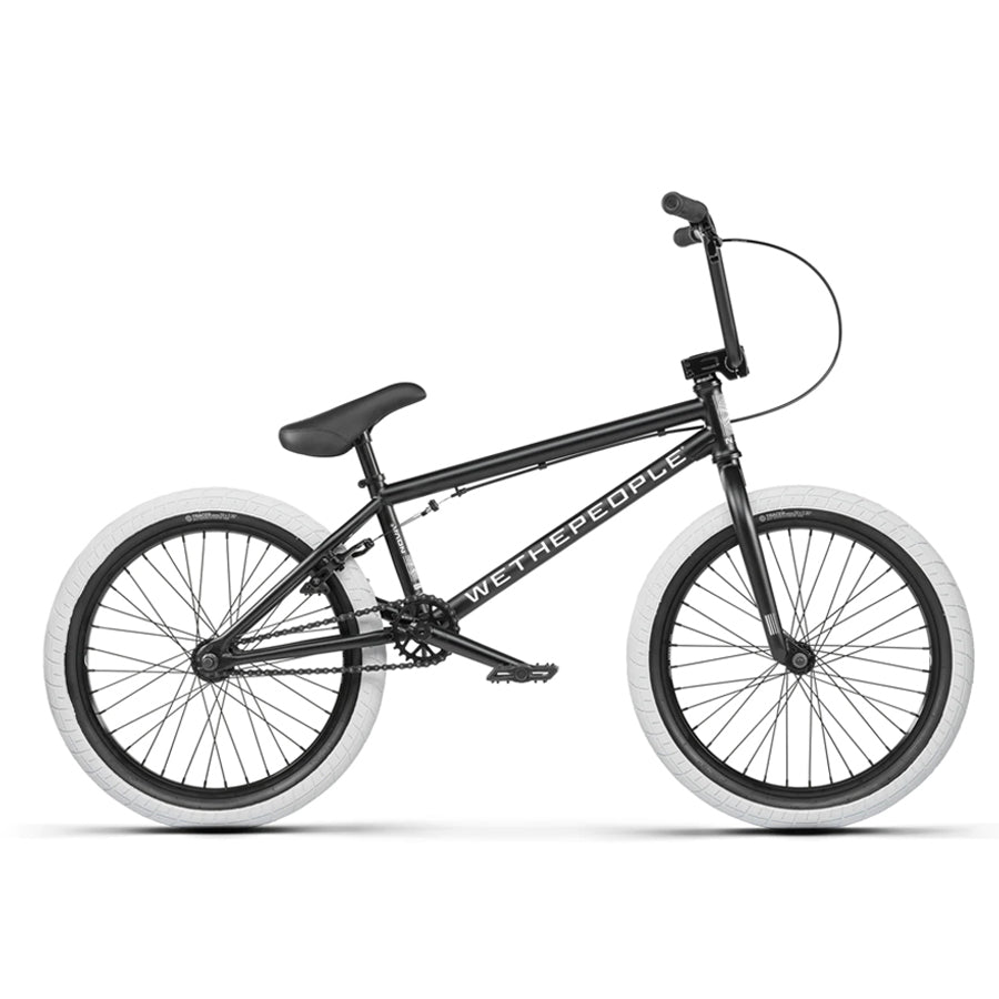 The Wethepeople Nova 20 Inch Bike features a black frame with white tires, adorned with the "WETHEPEOPLE" logo, and includes Salt Rookie Cranks for extra performance. Its sleek design ensures a ride that's both stylish and robust.