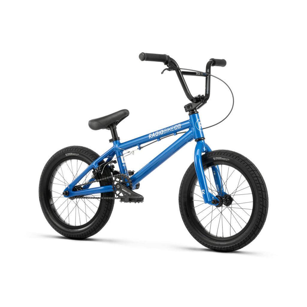 A blue Radio Dice 16 Inch Bike with black handlebars, seat, and Salt Traction tires. It has a compact 6061 Alloy frame and sturdy construction, ideal for stunts and tricks. The brand name "Radio Bike Co." is visible on the frame.