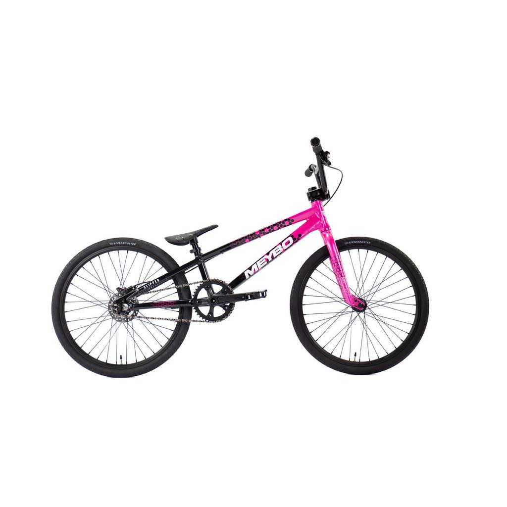 The Meybo 2026 Clipper Expert Bike, shown in pink and black with large tires, a black seat, and straight handlebars against a white background, is an ideal entry-level BMX race bike.