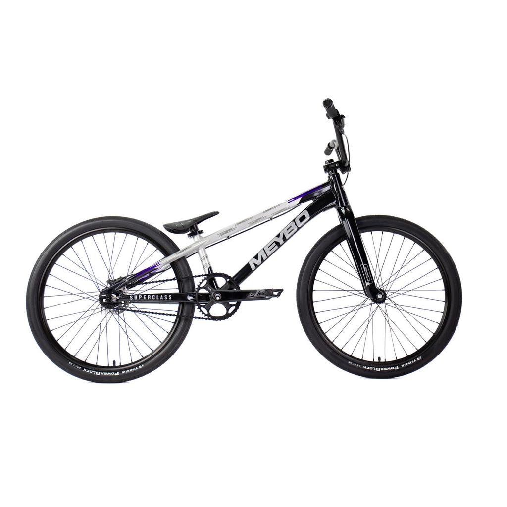 The Meybo 2026 Superclass Pro XL Cruiser Bike is a black and white BMX racing bicycle with bold "MEYBO" branding, large wheels, a straight top tube ideal for tall riders, and a padded seat, shown on a white background.