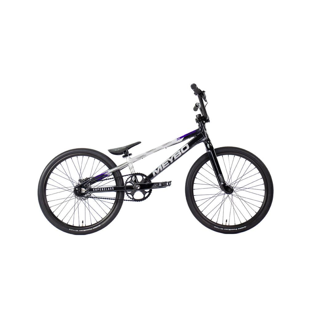 The Meybo 2026 Superclass Expert Bike is a black and white BMX racing bike with a lightweight frame, flat handlebars, and thin tires, ideal for tall riders, photographed from the side on a white background.