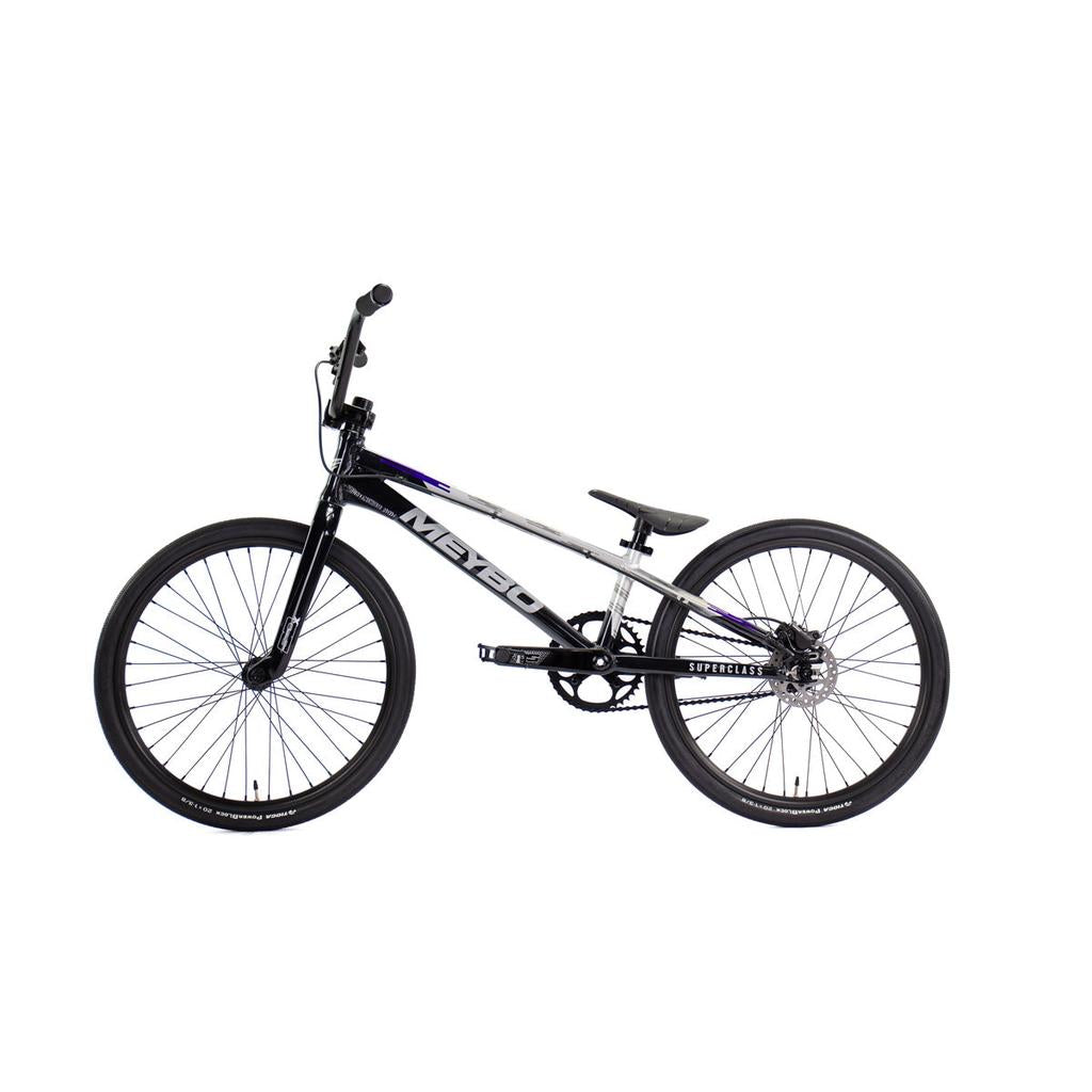 Side view of a black and silver Meybo 2026 Superclass Expert XL BMX racing bike with "MEYBO" branding, lightweight frame, thin tires, and elevated seat for tall riders, shown against a white background.