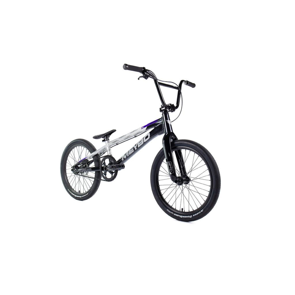The Meybo 2026 Superclass Pro XXL Bike is a black and silver BMX racing bike with a 22” top tube, lightweight frame, thick tires, and raised handlebar—perfect for tall riders. Photographed on a white background.