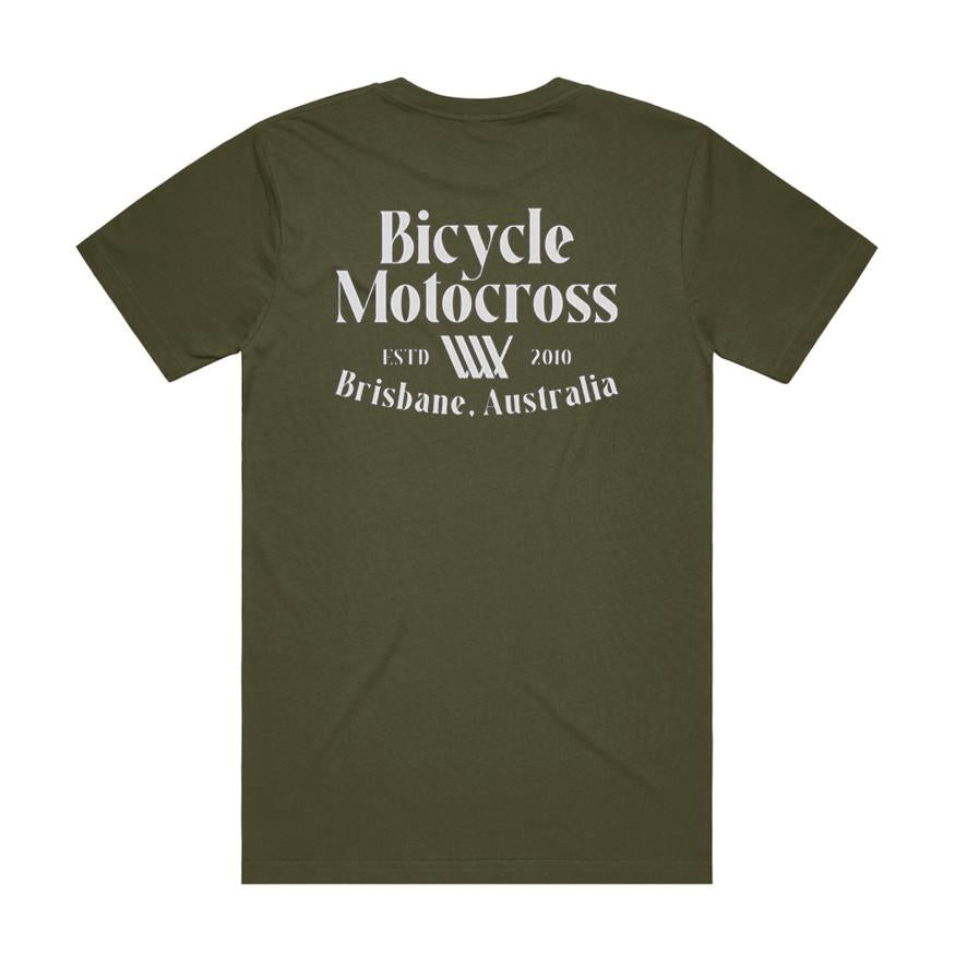 The LUXBMX Bicycle Motocross Tee Army is an olive green t-shirt featuring bold white text on the back that reads "Bicycle Motocross, ESTD 2010, Brisbane, Australia." This tee blends classic style with authentic BMX heritage.