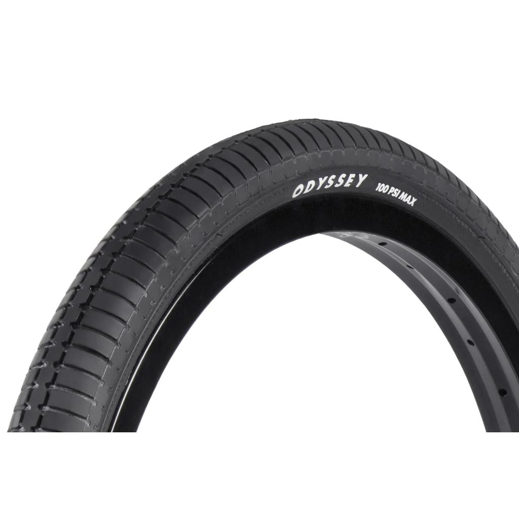 Close-up of a black Odyssey Frequency G 20 Inch Tyre with “ODYSSEY” and “100 PSI MAX” marked on the sidewall. This tyre features a smooth tread pattern made from a special compound for enhanced durability and performance.