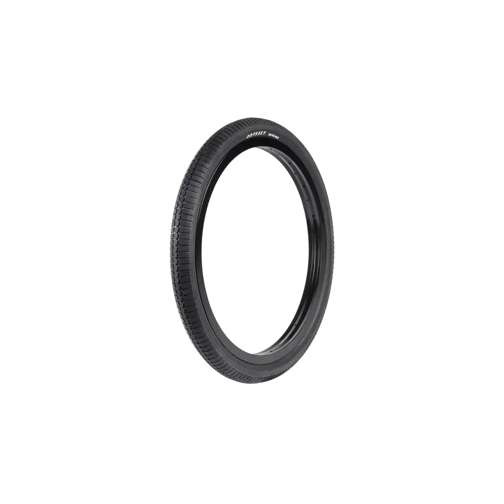 A single Odyssey Frequency G 20 Inch Tyre (Each) in black, featuring its distinctive compound tread, stands upright against a plain white background.