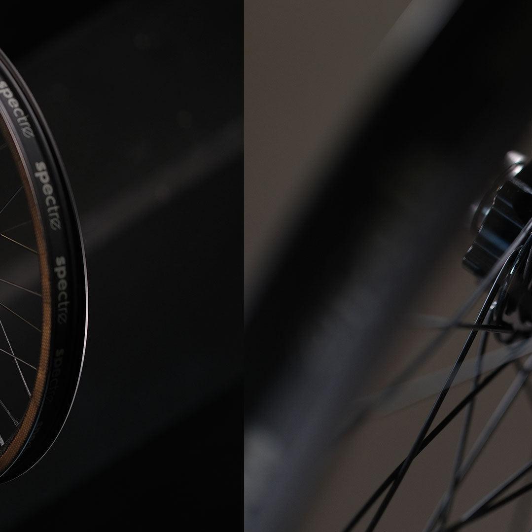 Close-up of a lightweight BMX wheel, highlighting the tire, spokes, and Onyx Helix 20mm hub against a dark background—showcasing the Spectre NME X Onyx Elite 20 Inch Disc Wheel Set (20mm/15mm).