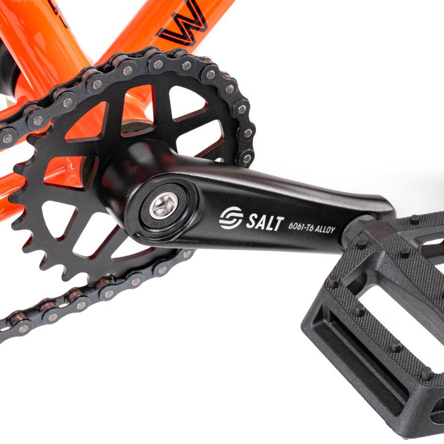 A Wethepeople Prime Drive 12 Inch Bike featuring a chain and a chain ring.