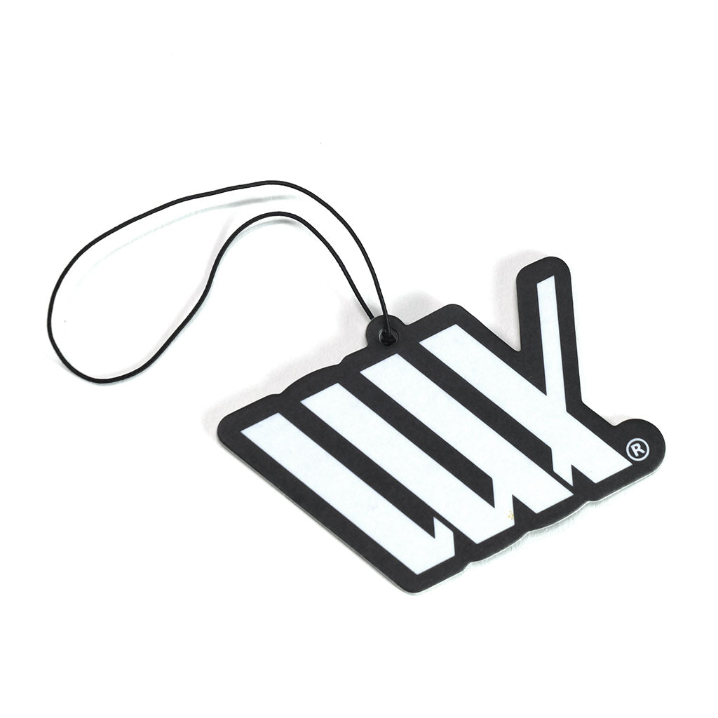 The LUXBMX Air Freshener - Josh Dove is a black and white forest-scented freshener with five diagonal tally marks and a black hanging string, designed by Josh Dove for a truly fresh aroma.