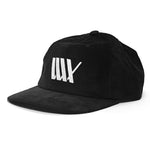 The LUXBMX Outfield Cap Black is a black cotton corduroy baseball cap with a flat brim, white embroidered LUX logo, and signature tally mark on the front—blending classic style with premium detailing.