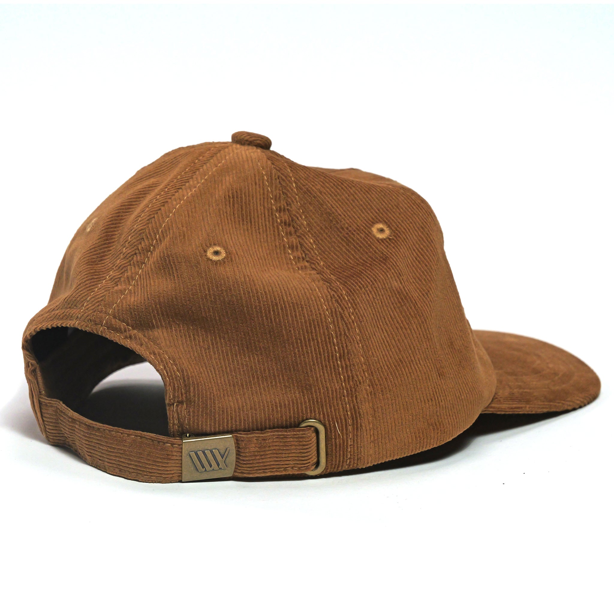 The LUXBMX Outfield Cap Brown is a brown corduroy baseball cap shown from the back, featuring a corduroy crown, adjustable strap with metal clasp, and an embroidered LUX logo.