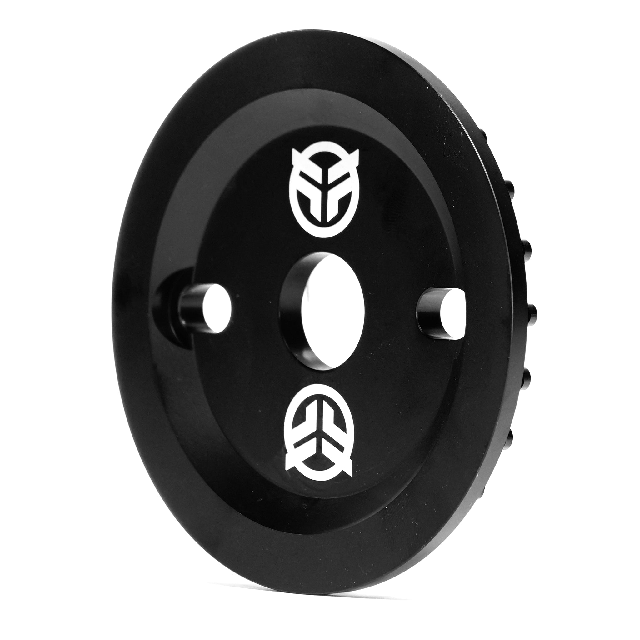 The Federal Code Guard Sprocket is a black, circular BMX sprocket featuring two small side holes, a central hole, and two white geometric logos—offering durability and style for BMX enthusiasts.