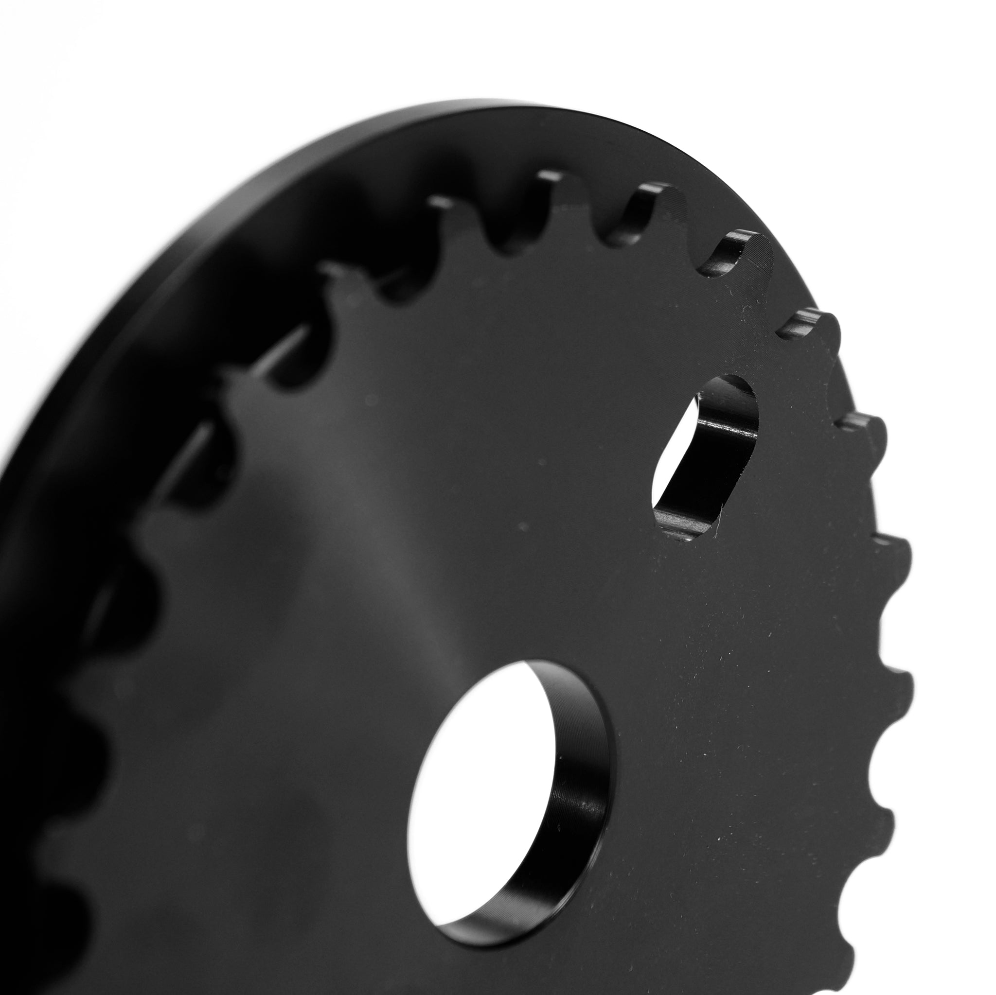 Close-up of the Federal Code Guard Sprocket in black metal, showing its circular center hole and edge teeth on a white background—ideal for BMX riders seeking durability and style.