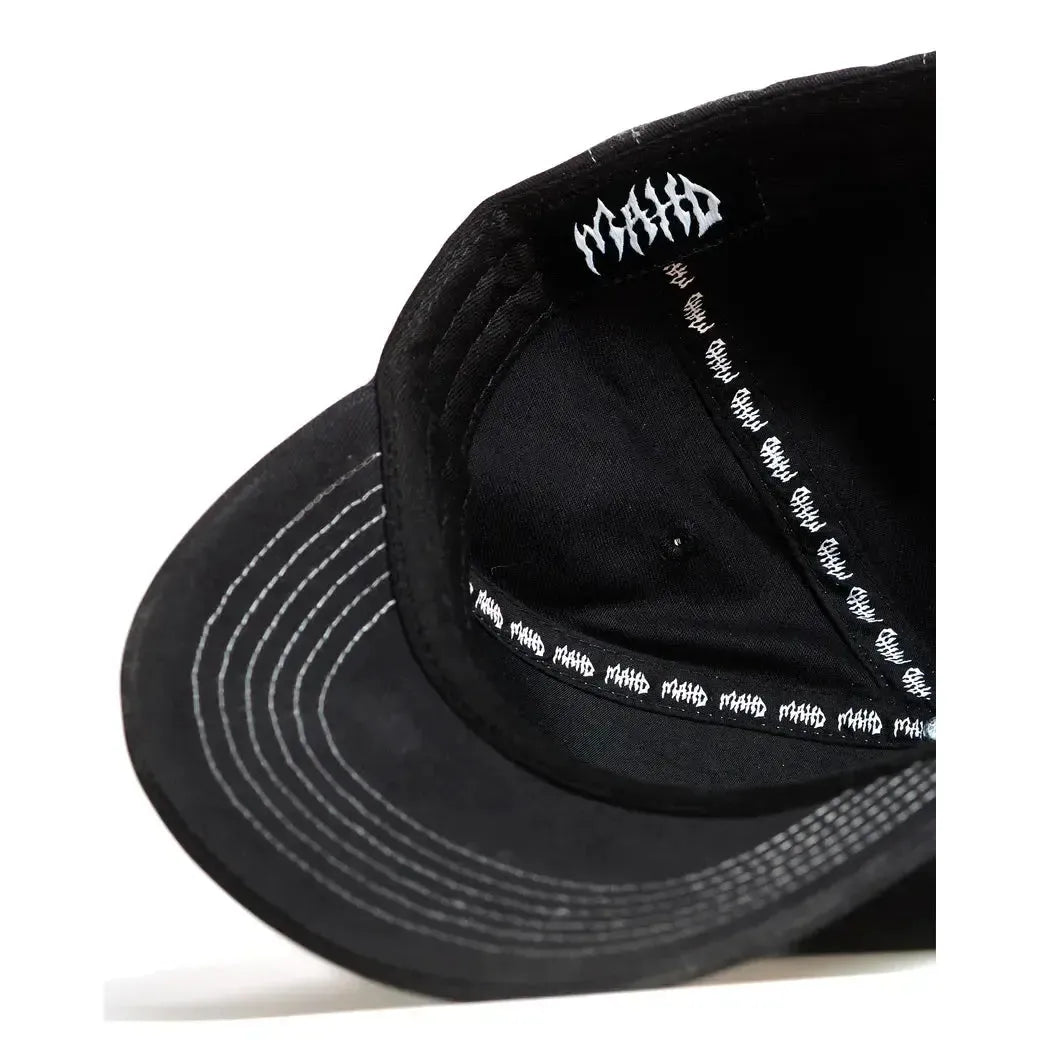 Close-up view of the inside of the black Mahd - Metal Hat, showing repeated white "MAHA" text on the sweatband and a single "MAHA" logo under the top panel.