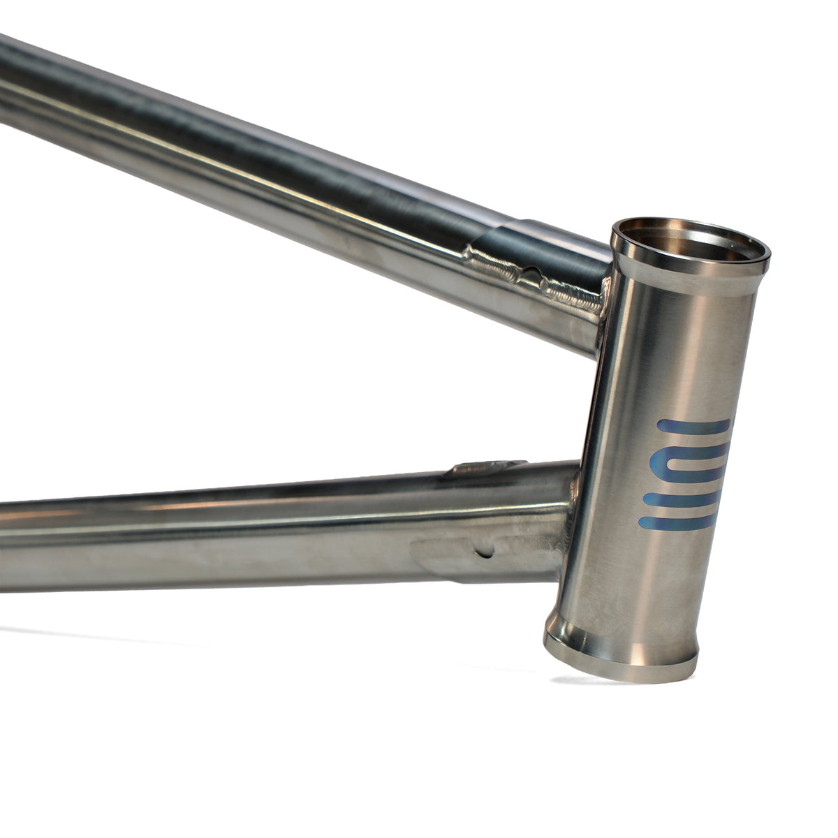 Close-up of the ION BMX Ti22 Titanium 22 Inch Frame with a cylindrical head tube at a 74-degree angle, featuring a simple blue geometric logo.