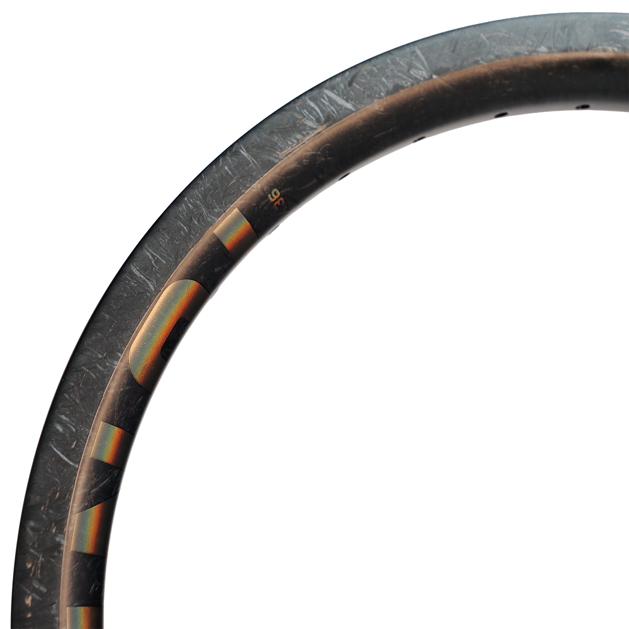 Close-up of the top edge of a carbon fiber badminton racket frame, showcasing texture and partial design details similar to those found on the ION BMX C18 Carbon Fiber 18 Inch Braking Rim.