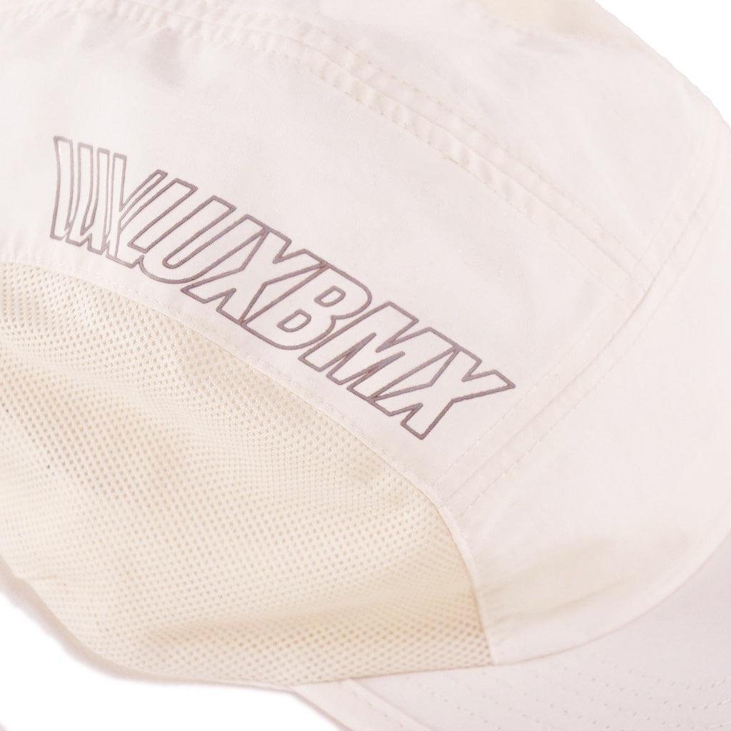 A LUXBMX Bike Athletics Cap - Ecru with the word luxbmx on it.