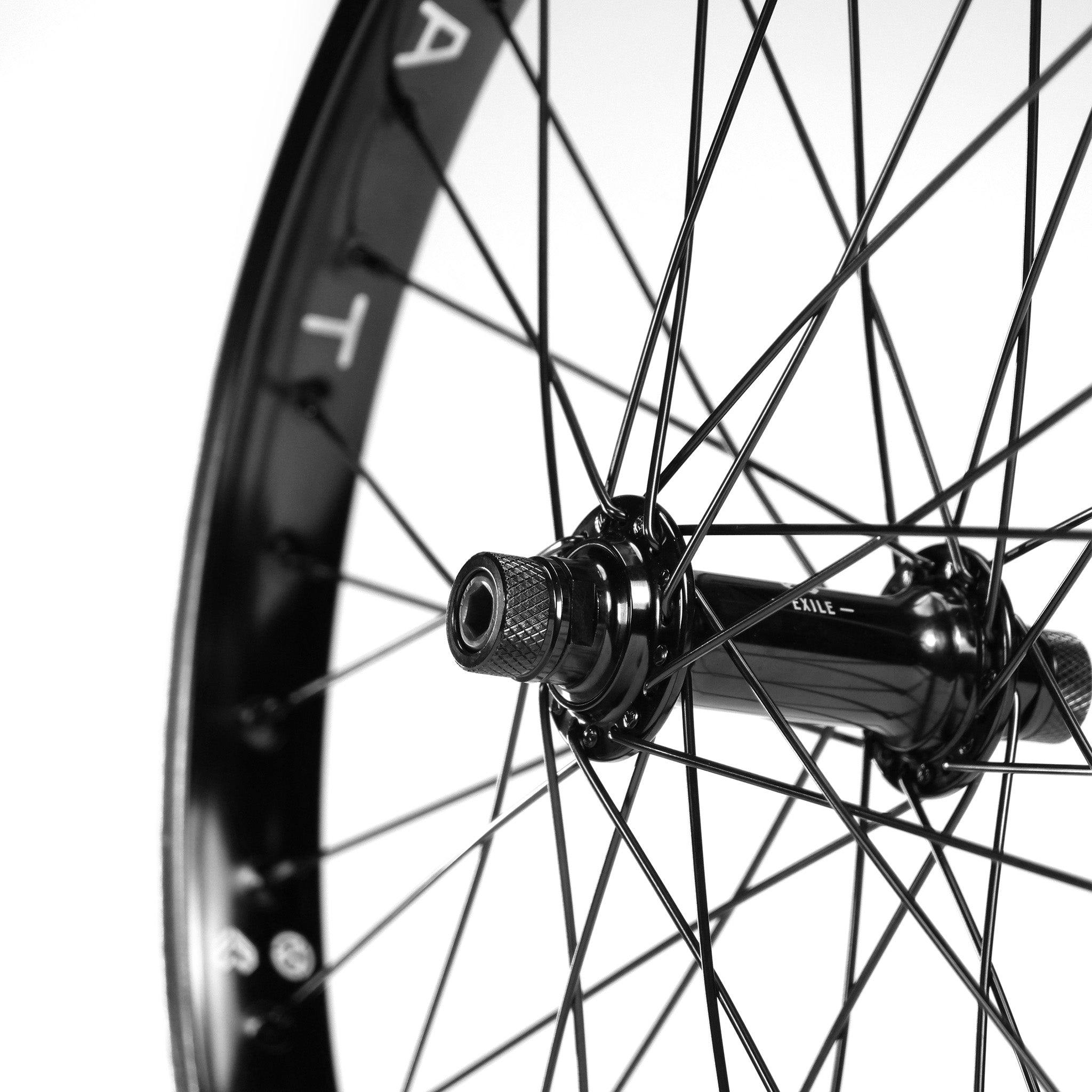 Close-up of an Eclat Locater / Exile Front Wheel with Éclat steel spokes and hub on a white background.