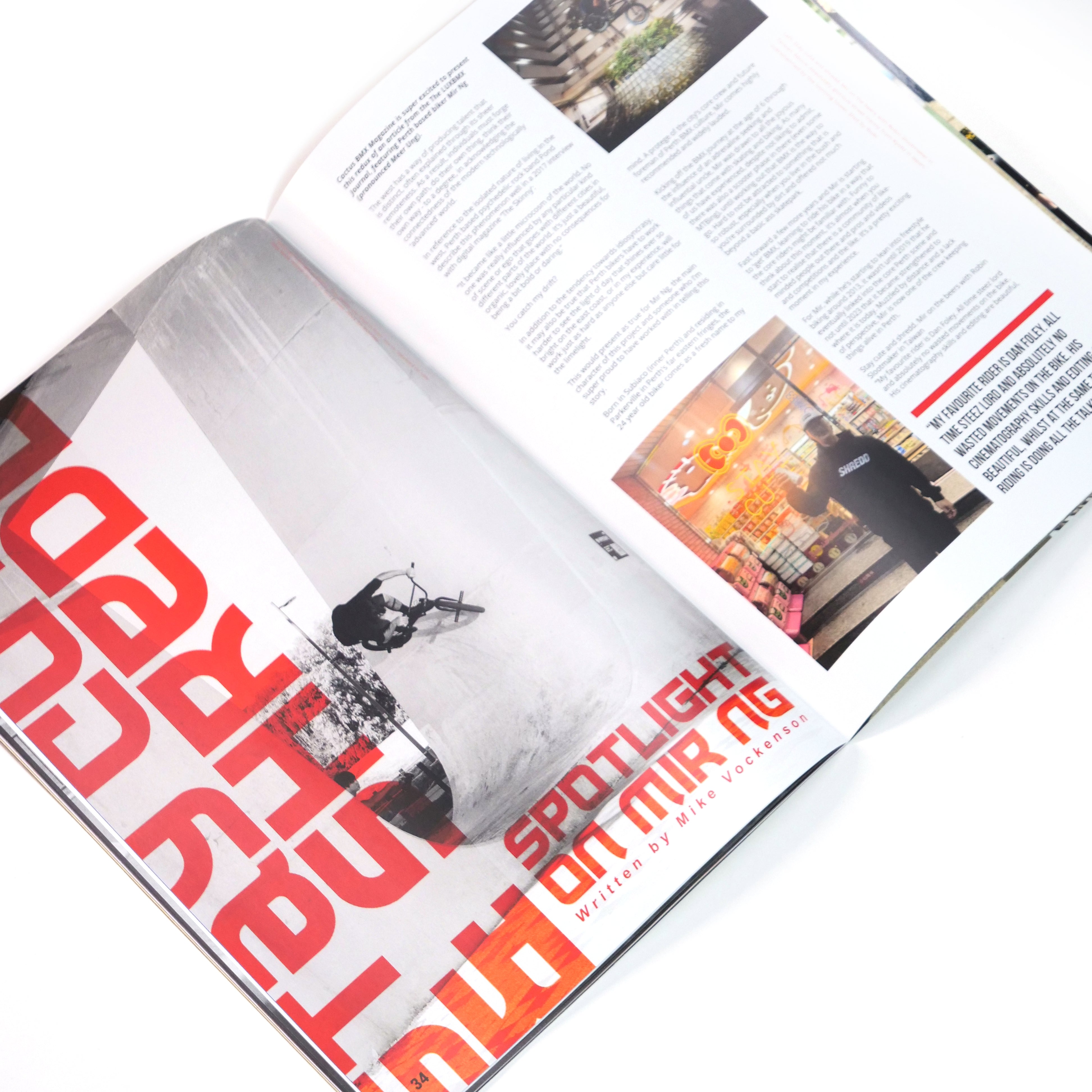 An open copy of Cactus BMX Mag - Issue 1 displays a vibrant two-page spread featuring "Spotlight on Miping," with photos of a cyclist and store interior surrounded by dynamic text and graphics in this Australian BMX magazine.