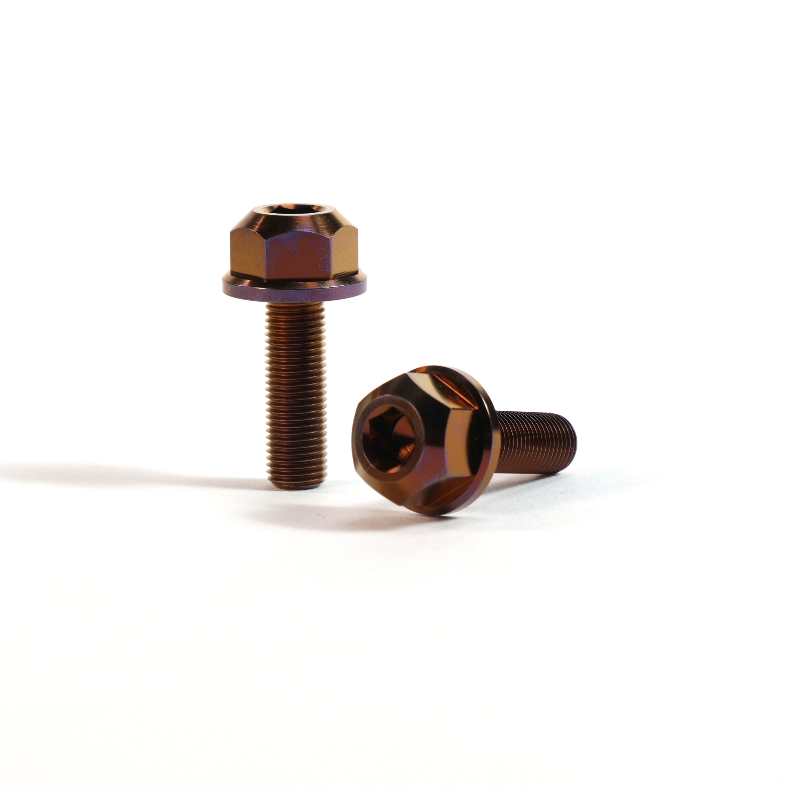 Two ION BMX Titanium GR5 Hex Axle Bolts, brown and CNC machined, are shown on a white background—one bolt upright, the other lying down.