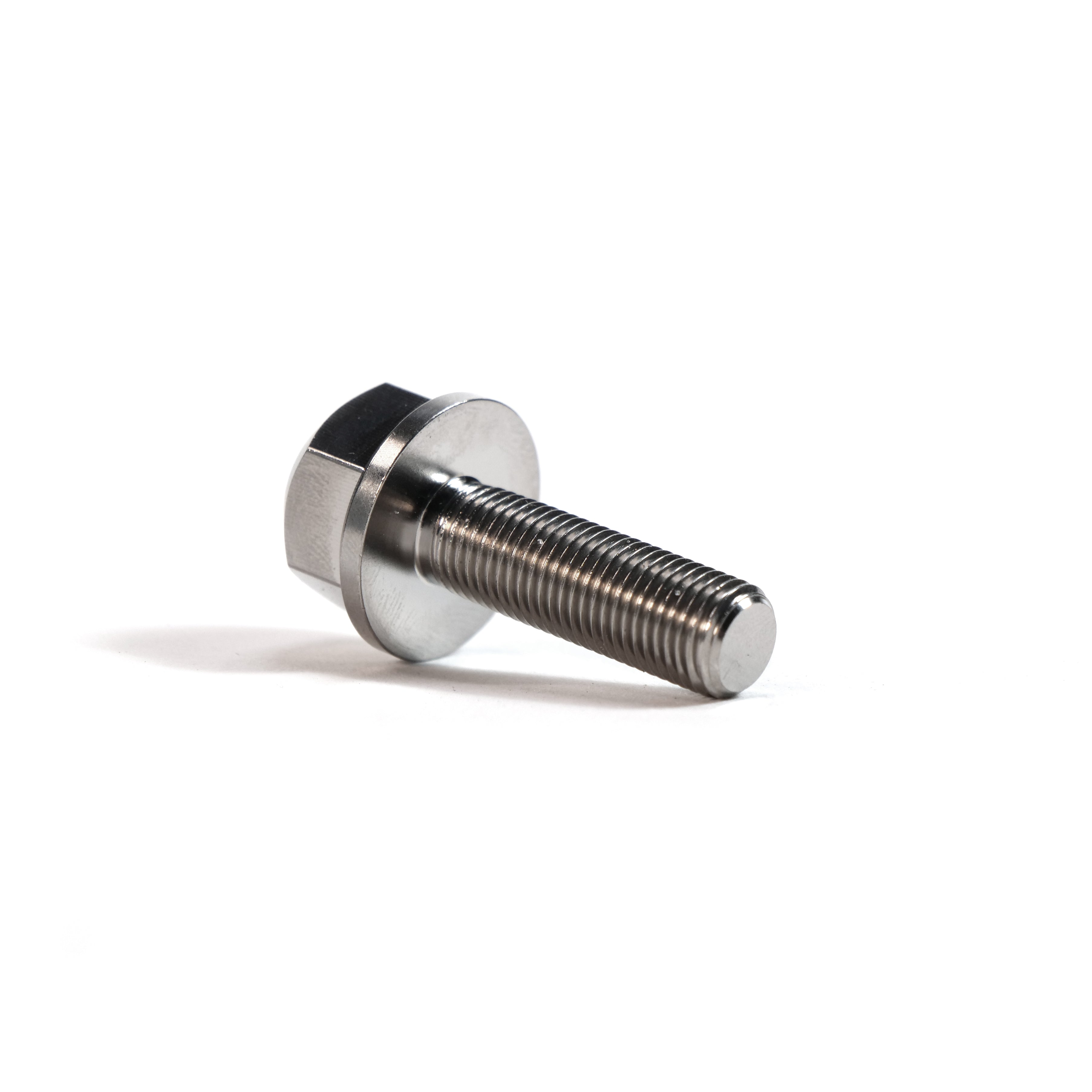 A close-up of the ION BMX Titanium GR5 Hex Axle Bolt, a CNC-machined metal bolt with a threaded shaft, often used as a BMX titanium axle bolt, shown resting on a white surface.