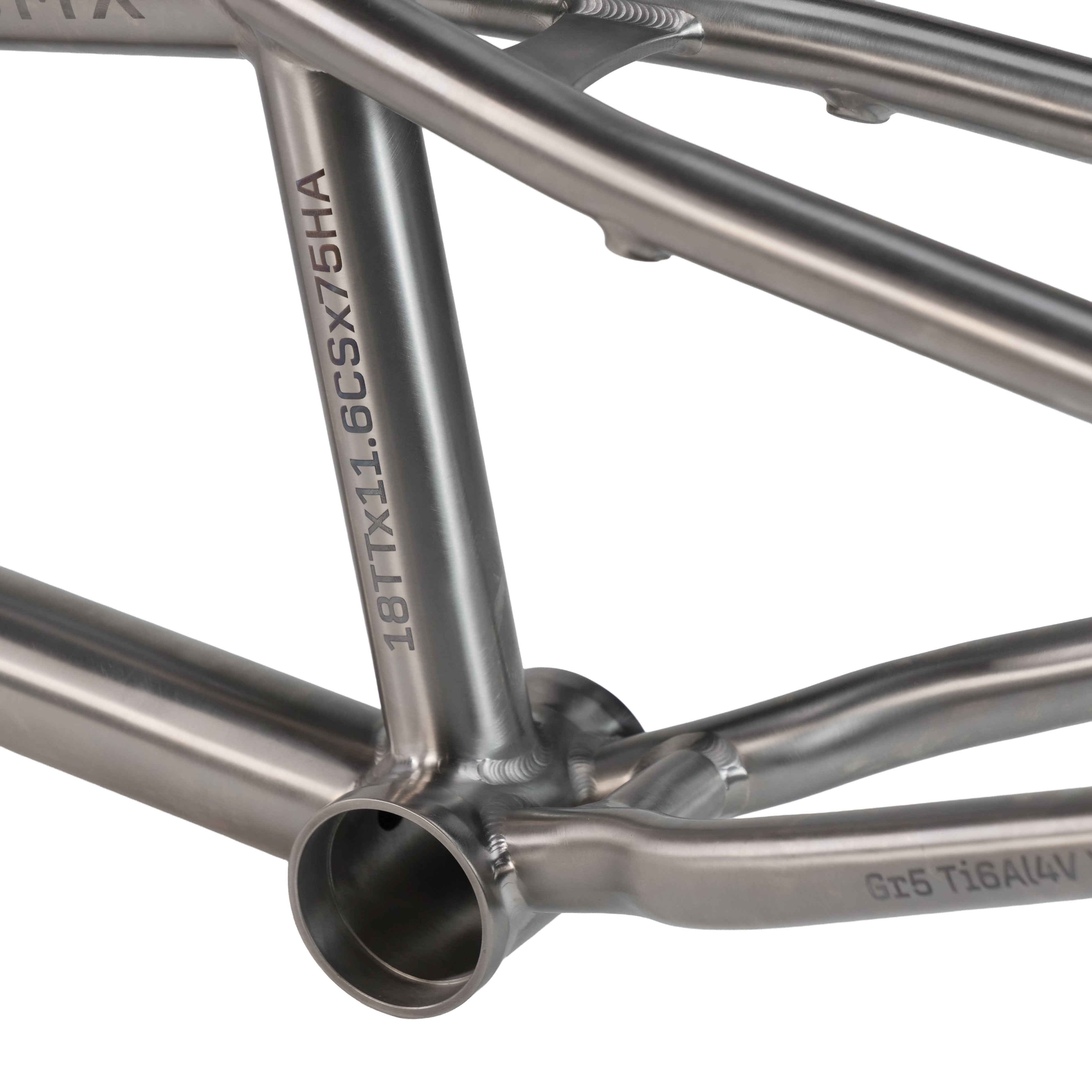 Close-up of the ION BMX Ti18 Titanium 18 Inch Frame showing its metallic finish, visible welds, and engraved alphanumeric text on the tubing.