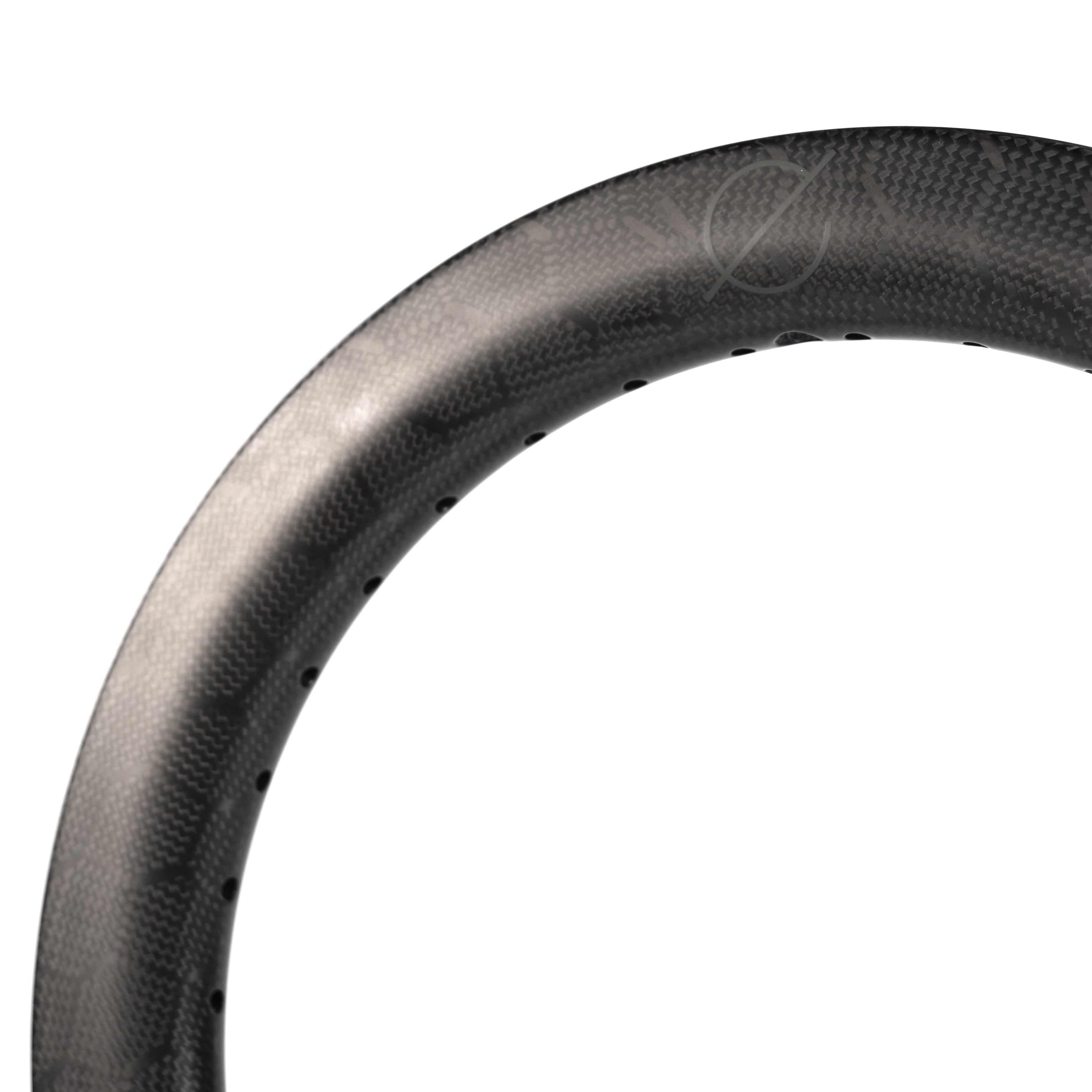 Close-up of the Spectre V2 Carbon Fiber 16 Inch 36H Brake Rim, showing spoke holes along the inner edge.