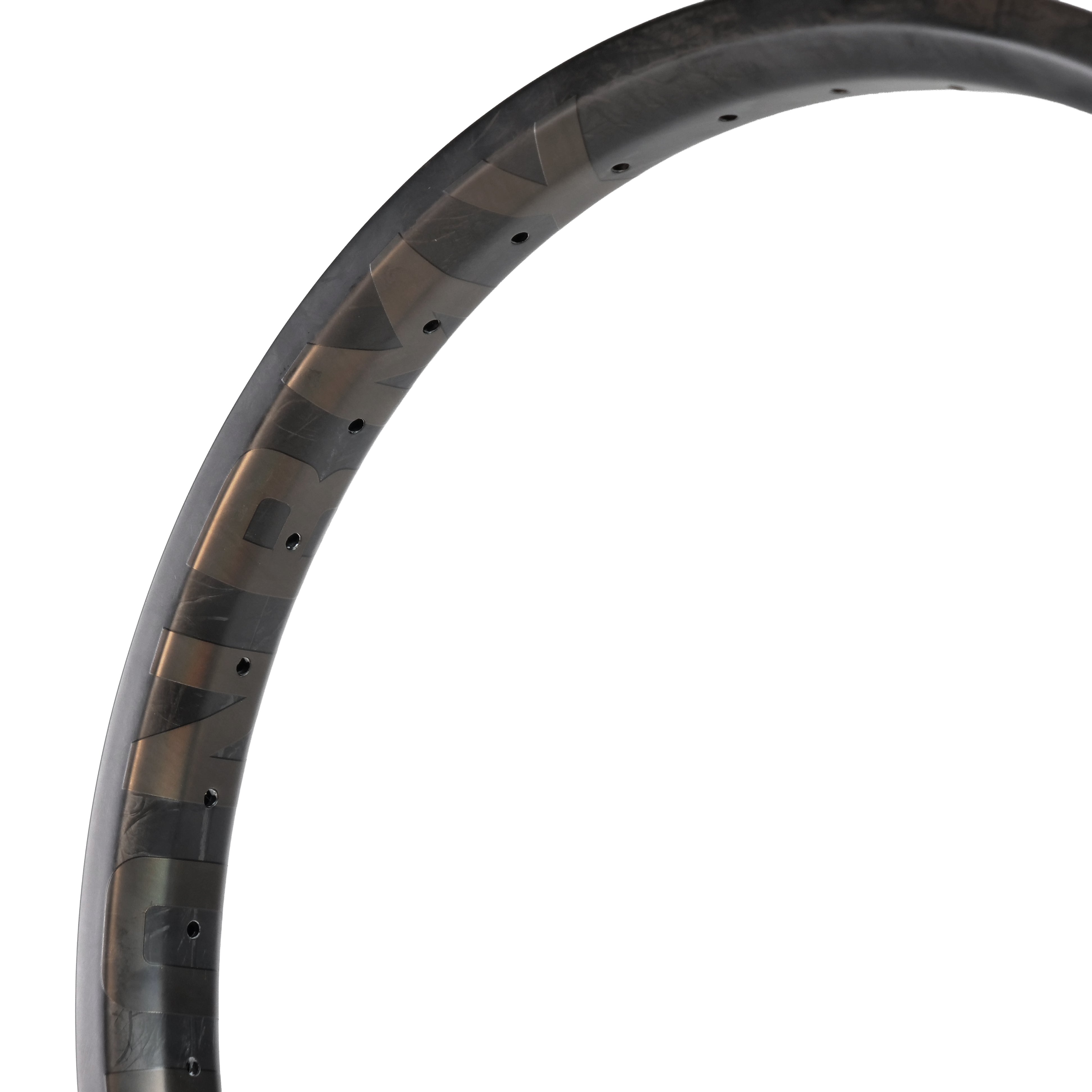 A close-up of the ION BMX C20 Carbon Fiber 20 Inch Brakeless Rim shows spoke holes and a partial logo on its matte surface, highlighting this high-performance BMX wheel component.