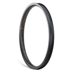 The ION BMX C22 Carbon Fiber 22 Inch Brakeless Rim stands upright against a white background, displaying spoke holes and a smooth, matte finish—ideal for riders seeking lightweight BMX rims.