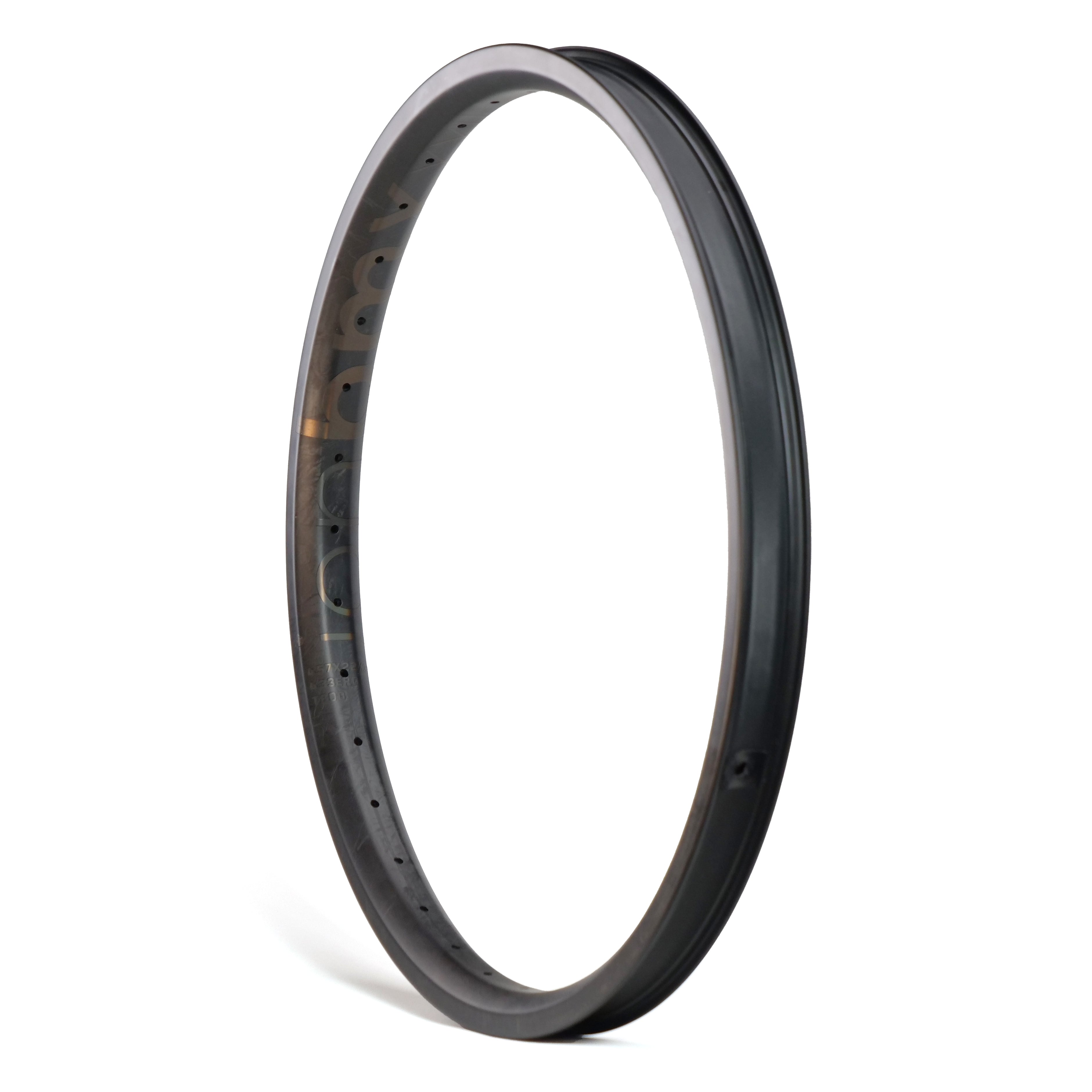 The ION BMX C22 Carbon Fiber 22 Inch Brakeless Rim stands upright against a white background, displaying spoke holes and a smooth, matte finish—ideal for riders seeking lightweight BMX rims.