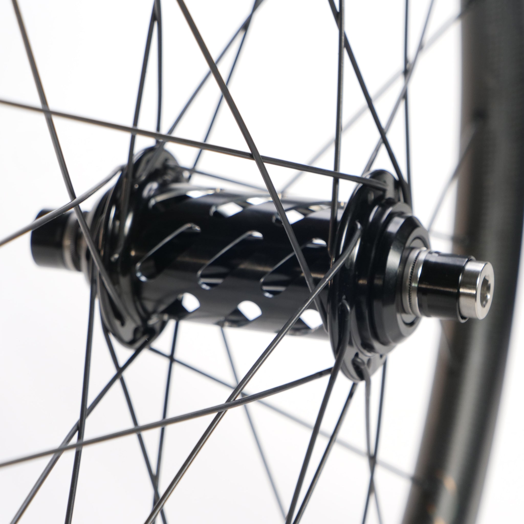 Close-up of the Spectre X Onyx 451 Disc Wheel Set hub, showing black spokes and a black hub. This alloy rim wheelset is designed for lightweight BMX race performance.