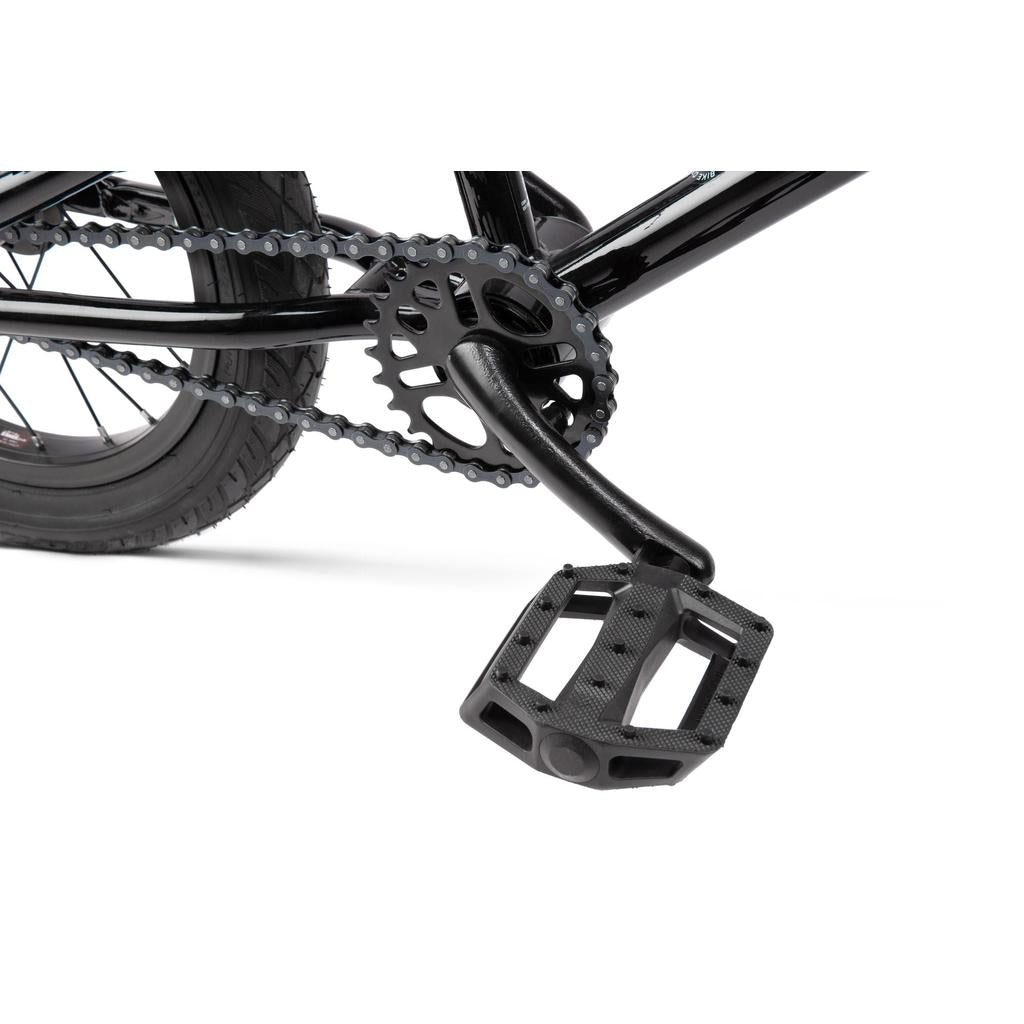 Close-up of a black crankset, pedal, chainring, and rear wheel on the Radio Revo 14 Inch bike against a white background—perfect for those seeking their first bike.