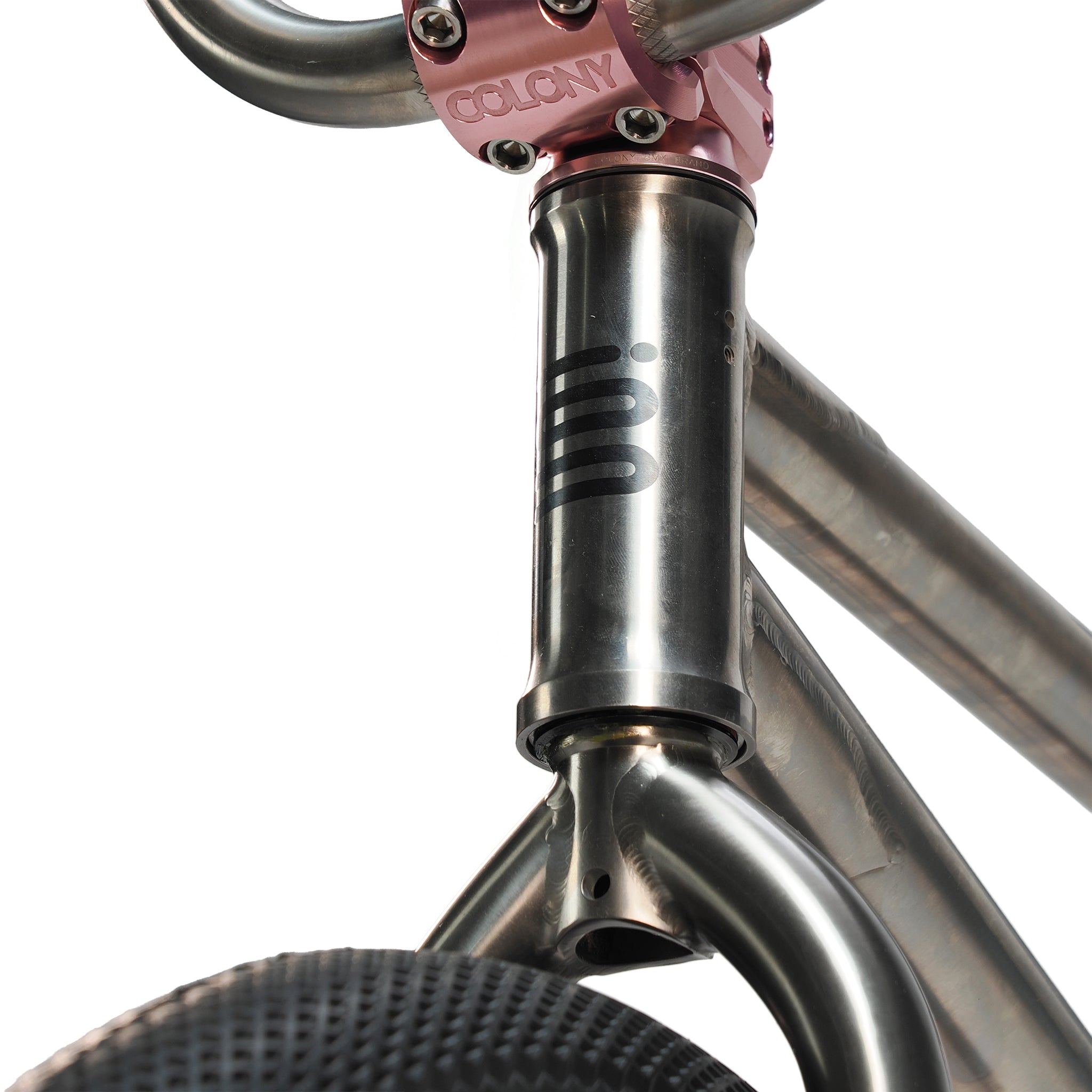 Close-up of the ION BMX Ti18 Custom Titanium 18 Inch Bike’s silver front frame, with a pink handlebar stem and black tire—highlighting its lightweight titanium design for freestyle BMX riders.