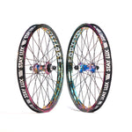 The Profile x Odyssey Near Earth Objects Wheel Set (Limited Edition) features two vibrant BMX wheels with black "STAY LUX" rims, multicolored spokes, and colorful hubs. Right Hand Drive wheel set option available.